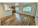 Bright and airy living room featuring hardwood floors and large windows with views of the neighborhood at 300 Dalton Blvd Blvd, Port Charlotte, FL 33952