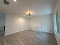 Well-lit bedroom boasts wood-look floors, recessed lighting, and a stylish chandelier at 4300 Avanti Cir, North Port, FL 34287