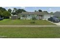 Well-manicured lawn and garden accentuate this single-story home with an attached one car garage at 4300 Avanti Cir, North Port, FL 34287