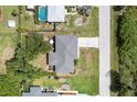 Overhead shot showcasing the house's roof, driveway, and surrounding neighborhood at 7104 Castilla St, Port Charlotte, FL 33981