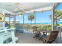 Screened balcony with seating and ocean view at 7500 Palm Island S Dr # 2111, Placida, FL 33946