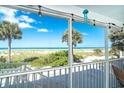 Screened balcony with ocean view and palm trees at 7500 Palm Island S Dr # 2111, Placida, FL 33946
