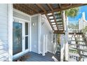 Condo entrance featuring stylish stairs and a secure, well-lit doorway at 7500 Palm Island S Dr # 2111, Placida, FL 33946