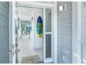 Bright foyer boasting sleek tile flooring and a coastal-themed surfboard decor accent at 7500 Palm Island S Dr # 2111, Placida, FL 33946