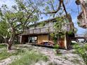 Charming home on stilts featuring a spacious deck, outdoor space, and lush greenery at 8416 Little Gasparilla Is, Placida, FL 33946