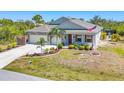 Well-maintained home with a stone veneer, two-car garage, and a spacious, well-manicured front yard at 9213 Spring Cir, Port Charlotte, FL 33981