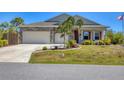 Beautiful single-Gathering home featuring stone accents, a two-car garage, and neat landscaping at 9213 Spring Cir, Port Charlotte, FL 33981