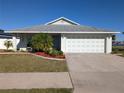 Charming single Gathering home with well-maintained lawn and landscaping, two car garage, and sunny front porch at 1405 Blossom Bayou Cir, Ruskin, FL 33570
