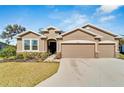 Beautiful single story home with a two car garage and lovely landscaping at 14069 Wineberry Dr, Dade City, FL 33525