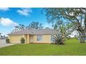 Inviting single-Gathering home with a neat front yard, offering curb appeal and a welcoming atmosphere at 3143 Grayton Dr, Spring Hill, FL 34609