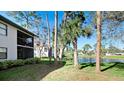 Scenic view of the pond from the backyard, surrounded by mature trees at 4655 46Th Street Ct # 101, Bradenton, FL 34210