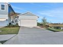 Light blue two-story house with a white garage door and landscaping at 9136 Gulf Haven Dr, Parrish, FL 34219