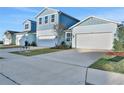 Row of light blue houses with white garage doors and landscaping at 9136 Gulf Haven Dr, Parrish, FL 34219