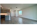 Bright living room with gray tile floors and an open kitchen at 9148 Gulf Haven Dr, Parrish, FL 34219