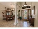 Formal dining room with wood table and chairs, and a large window at 254 Rotonda E Blvd, Rotonda West, FL 33947