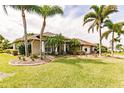 Single-story house with a landscaped yard and palm trees at 254 Rotonda E Blvd, Rotonda West, FL 33947
