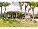 Single-story house with a landscaped yard and palm trees at 254 Rotonda E Blvd, Rotonda West, FL 33947