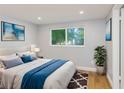 Bright bedroom with a comfortable bed and large window overlooking the garden at 1004 Greenleaf Way, Tarpon Springs, FL 34689