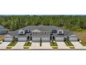 Five-unit townhome building with gray exterior and white garage doors at 9222 Gulf Haven Dr, Parrish, FL 34219