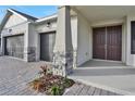 Front entrance with double doors and stone columns at 7474 Sea Manatee St, Parrish, FL 34219