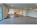 Open kitchen with an island and gray tile floors at 7490 Sea Manatee St, Parrish, FL 34219
