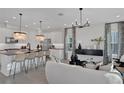 Modern living room featuring an island, pendant lighting, and an open concept design at 168 Eagleston Ln, Lakewood Ranch, FL 34240
