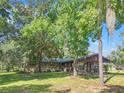 House exterior showcasing stone facade and landscaping at 5191 Cyril Dr, Dade City, FL 33523