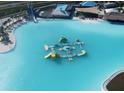 Aerial view of a crystal lagoon with floating obstacle course at 7442 Sea Manatee St, Parrish, FL 34219