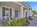 Inviting front porch with seating area, and nicely landscaped walkway at 7458 Sea Manatee St, Parrish, FL 34219