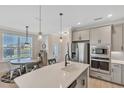 Modern kitchen with center island, stainless steel appliances, and ample counter space at 7578 Sea Oak Ct, Parrish, FL 34219