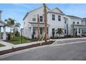 Modern two-story home featuring clean lines, fresh landscaping, and a inviting light blue front door at 176 Eagleston Ln, Lakewood Ranch, FL 34240
