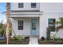 Charming light blue front door invites you into this beautifully landscaped, two-story modern home at 176 Eagleston Ln, Lakewood Ranch, FL 34240