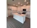 Modern kitchen featuring white cabinets, quartz countertops, and an island at 180 Eagleston Ln, Lakewood Rch, FL 34240