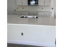 Modern kitchen island with white cabinets and quartz countertop at 180 Eagleston Ln, Lakewood Rch, FL 34240