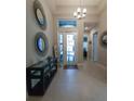 Bright and spacious entryway with tile flooring and decorative mirrors at 5013 Sevilla Shores Dr, Wimauma, FL 33598