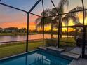 Screened-in pool and patio with sunset view at 5013 Sevilla Shores Dr, Wimauma, FL 33598