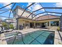 Large screened-in pool and spa with outdoor kitchen at 5704 Arnie Loop, Lakewood Ranch, FL 34211