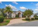 Beautiful house with a large driveway, palm trees, and lush landscaping at 9321 Butler Blvd, Weeki Wachee, FL 34613