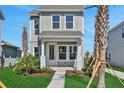 Two-story home with a inviting front porch, neat landscaping, and blue sky at 9019 Rothman Ln, Lakewood Ranch, FL 34240