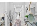 Bright hallway features tile flooring and stylish decorative accents at 13557 Willow Bluestar Loop, Riverview, FL 33579