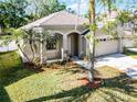 Single story home with a two-car garage and a palm tree in a well-maintained yard at 1652 Open Field Loop, Brandon, FL 33510
