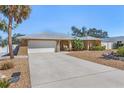 Well-maintained single-story home with a two-car garage, desert landscaping, and a concrete driveway at 909 Dawn St, Venice, FL 34285