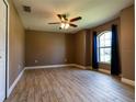 Comfortable bedroom with wood-look tile, fan, neutral paint, and natural light at 4154 Duluth Ter, North Port, FL 34286