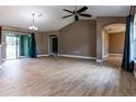 Spacious living room featuring tile floors, ceiling fan, and sliding glass doors at 4154 Duluth Ter, North Port, FL 34286