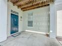 Covered entrance with dark teal door, white columns and a view of the wooden ceiling above at 4007 Bangalow Palm Ct # 4007, Tampa, FL 33624