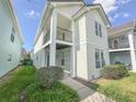 Charming two-story home with balcony, manicured lawn, and neatly trimmed bushes at 4007 Bangalow Palm Ct # 4007, Tampa, FL 33624
