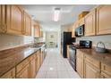 Spacious kitchen with granite countertops, stainless steel appliances, and white tile flooring at 33021 Ranch Rd, Dade City, FL 33523