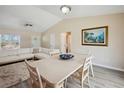 Bright open-concept living area with vaulted ceilings and a comfortable white sofa at 33021 Ranch Rd, Dade City, FL 33523