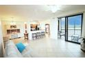 Spacious living area with open floorplan flowing to the kitchen and a sliding glass door to the screened patio at 7005 River Hammock Dr # 207, Bradenton, FL 34212