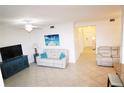 Inviting living room with tile flooring, a contemporary sofa, a cabinet and adjacent seating area at 7005 River Hammock Dr # 207, Bradenton, FL 34212